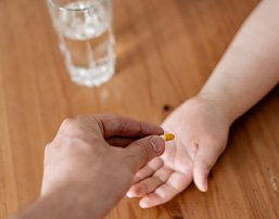 A parent handing a child an oral sedative