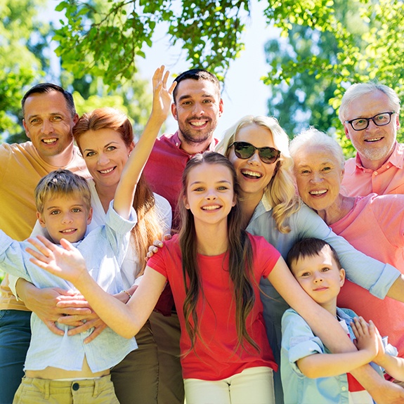 Three generations of family smiling together after family dentistry