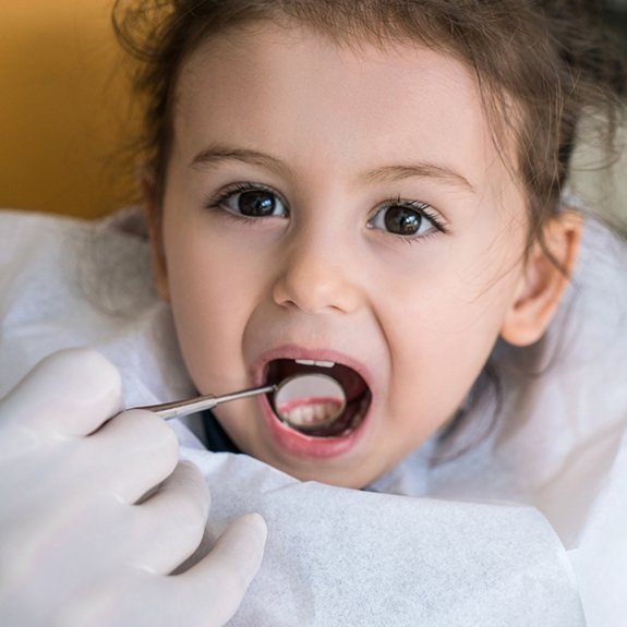 Little girl examined after tooth-colored filling placement