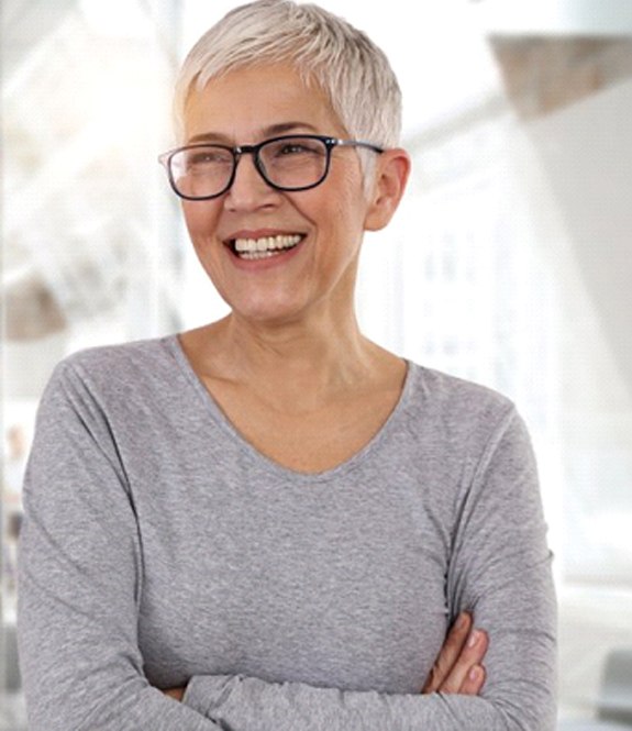 older woman smiling with dental crowns in Grand Prairie