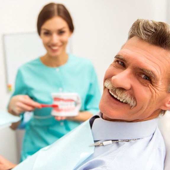 senior man at a denture consultation with his dentist in Grand Prairie