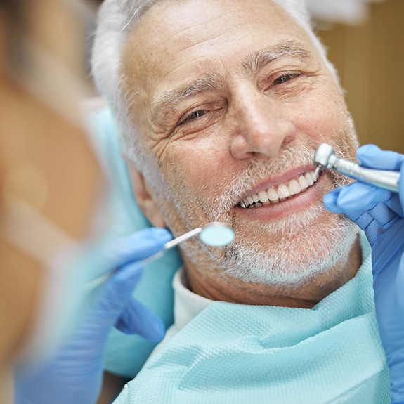 patient smiling while visiting dentist