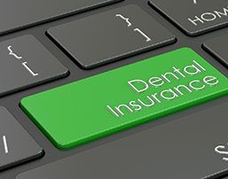 Green dental insurance button on keyboard