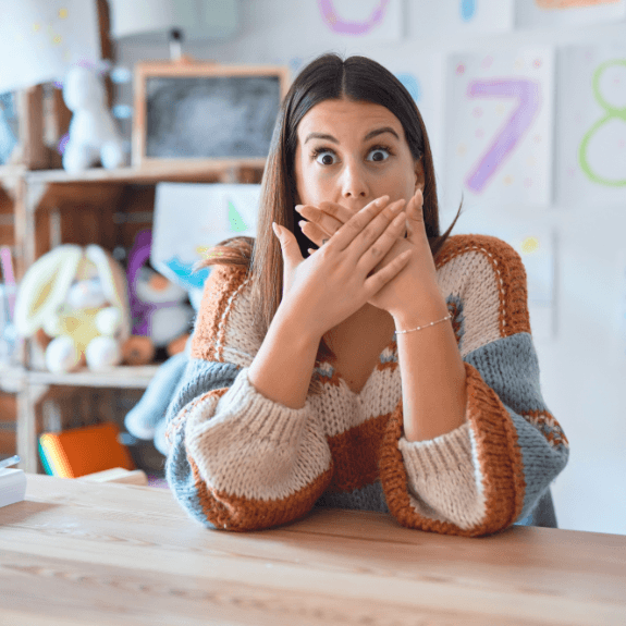 Woman experiencing a dental emergency covering her mouth