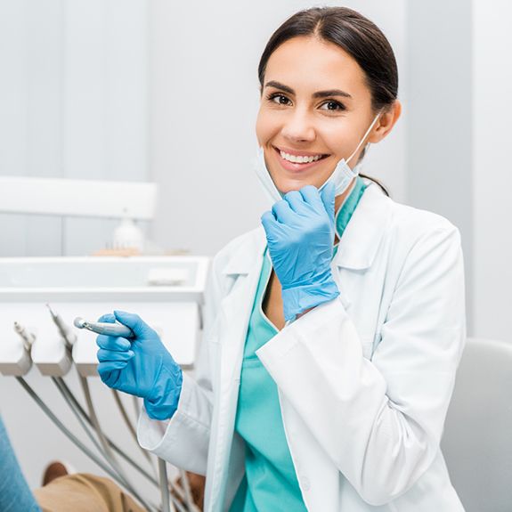 Dentist smiling during teeth cleaning