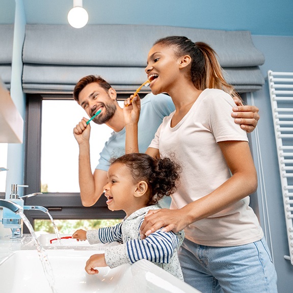 Family brushing teeth together