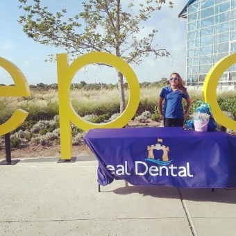 Dental team member at community event booth