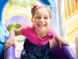 Young girl with healthy smile after children's dentistry