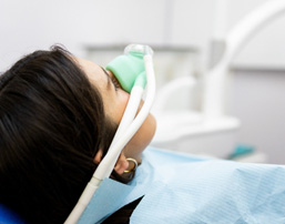 Closeup of patient breathing in nitrous oxide in treatment room