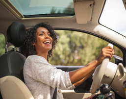 Woman smiling while driving