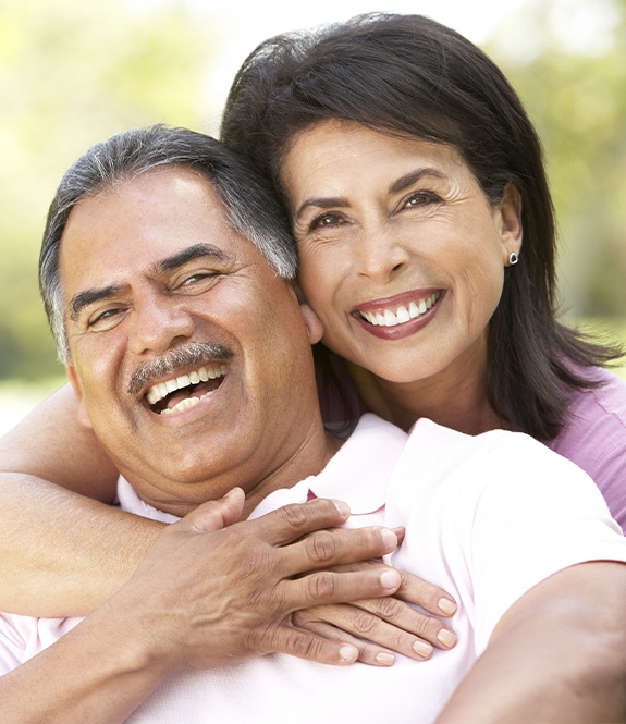 Older man and woman with healthy smiles after periodontal therapy