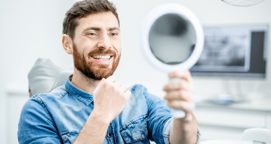 Man looking at smile during dental checkup