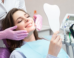 A young woman admiring the results of cosmetic dentistry