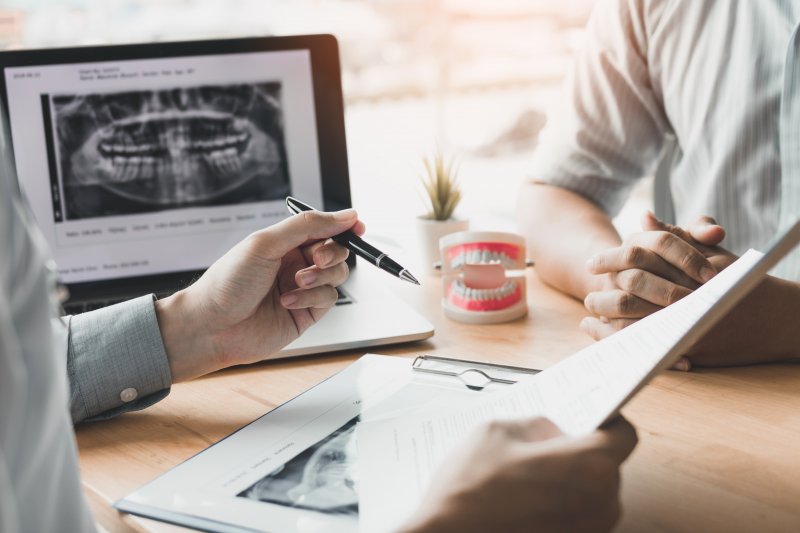 Dentist reviewing paperwork with patient