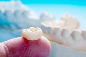 close up of a dental crown on a person’s finger 