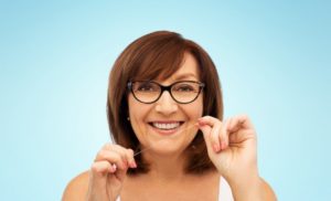 woman flossing to prevent dental emergencies