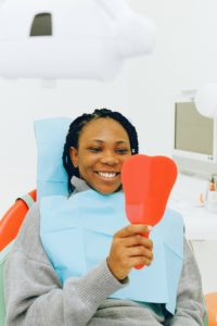 Female dental patient looking in mirror