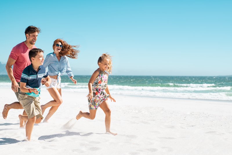 family playing on the beach