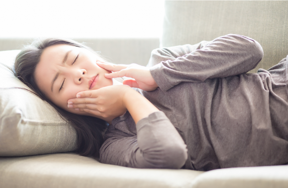 Woman trying to sleep with toothache